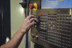 Staff Sgt. Jared Henden, 2nd Maintenance Squadron Fabrication Flight aircraft metals technology journeyman, adjusts the settings of the Computer Numerical Controlled machine at Barksdale Air Force Base, La., Sept. 13, 2016. It would take hours to create a component manually, but using the CNC will take a considerably less amount of time while being precise to 0.001 of an inch. (U.S. Air Force photo/Airman 1st Class Stuart Bright)